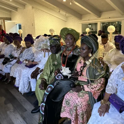 Bride sitting on grooms parent's lap